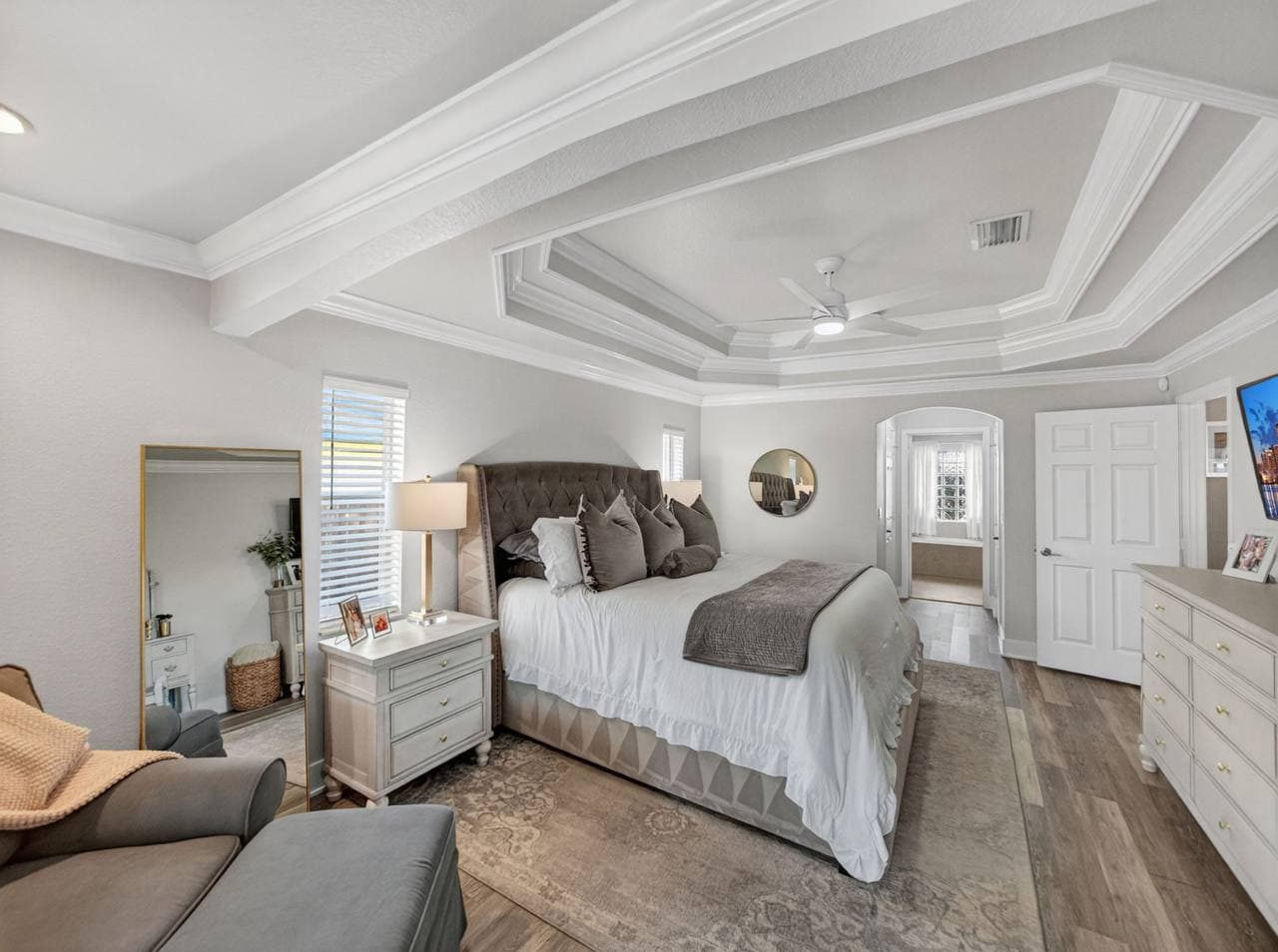 Master bedroom with tray ceiling and pool-view doors